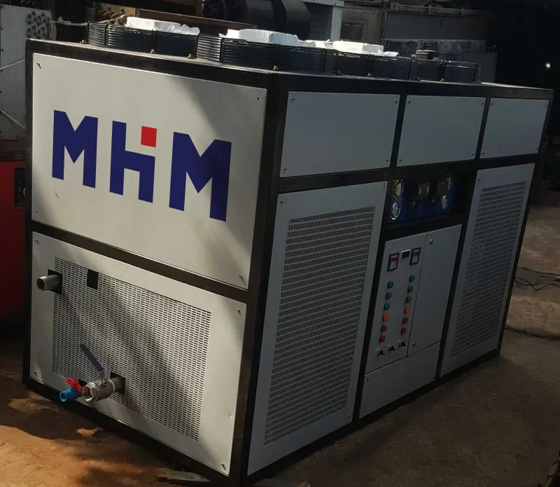 Air cooled chiller unit from the side, showing the condenser coil and control panel