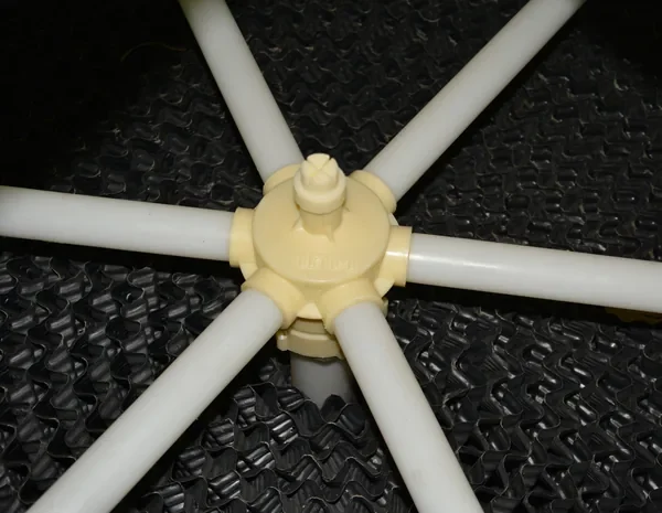Cooling tower water distribution pipe with rotating arms