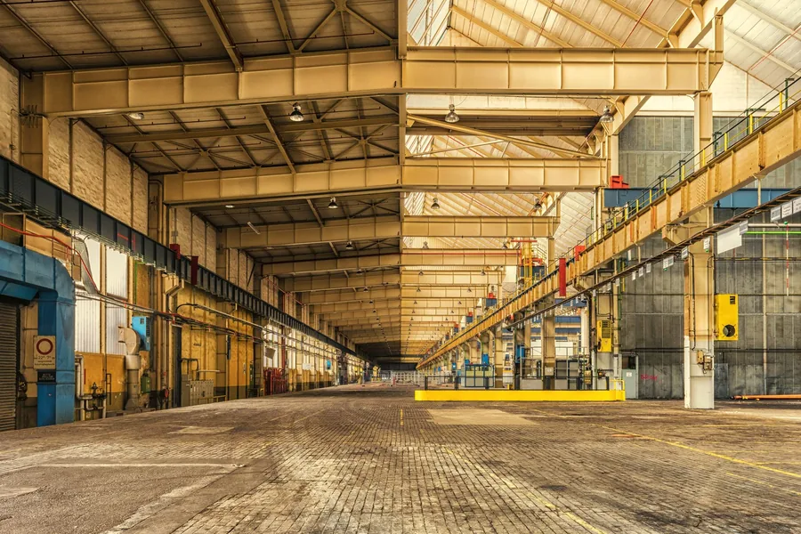 Interior of a large industrial warehouse that relies on roof and wall ventilation