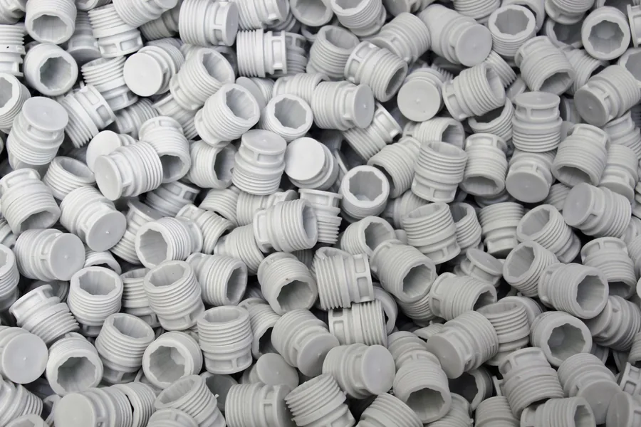 Injection-moulded plastic screw caps from a moulding line